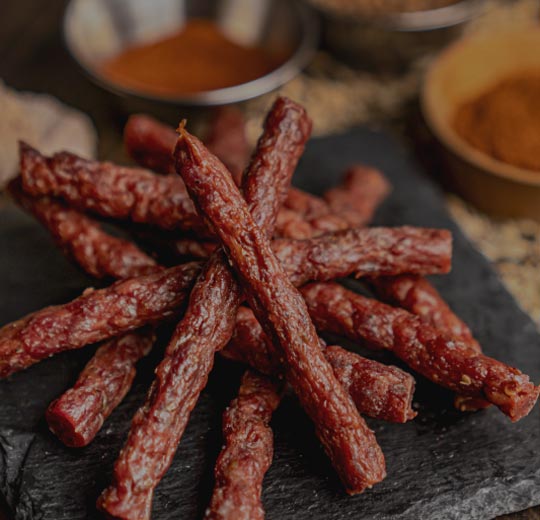 Choose your taste or tastes of choice and enjoy dried kosher sausage sticks and strips by Holy Jerky